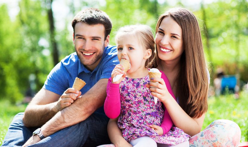a family enjoying ice cream cone outdoors